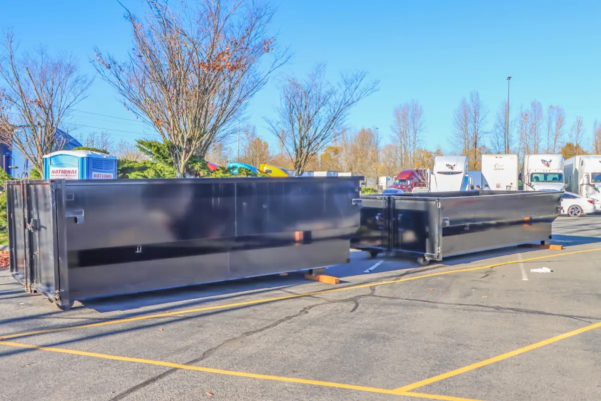 Professional dumpster rental service with roll-off container on residential driveway in El Dorado